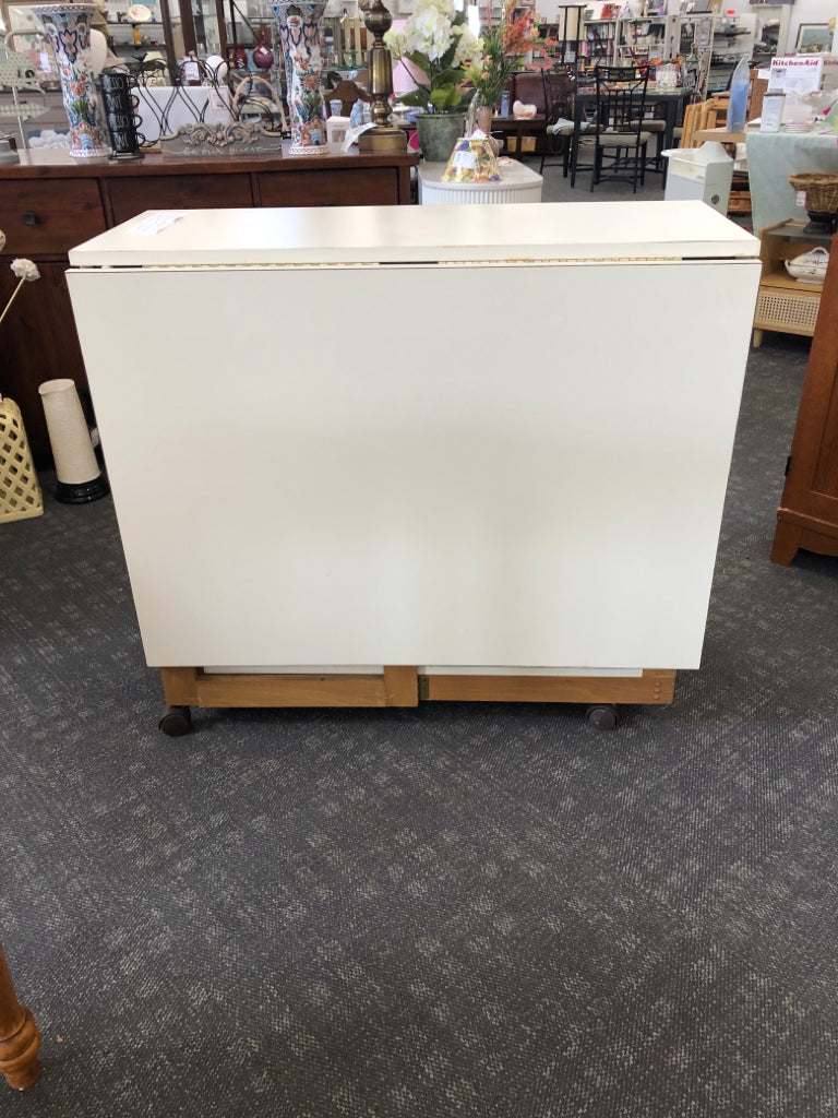 CREAM QUILT/ CRAFT TABLE ON WHEELS W 2 DRAWERS AND FOLD DOWN.