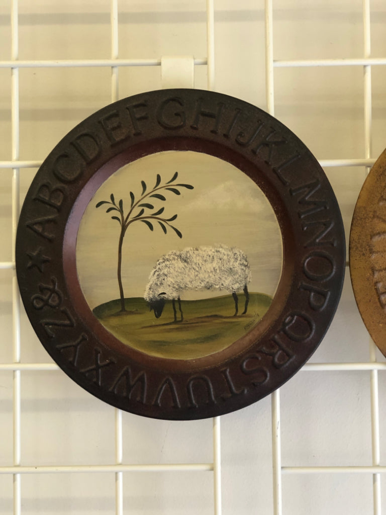 2 CIRCULAR PRIMITIVE SHEEP ALPHABET TIN PLATE WALL HANGING.