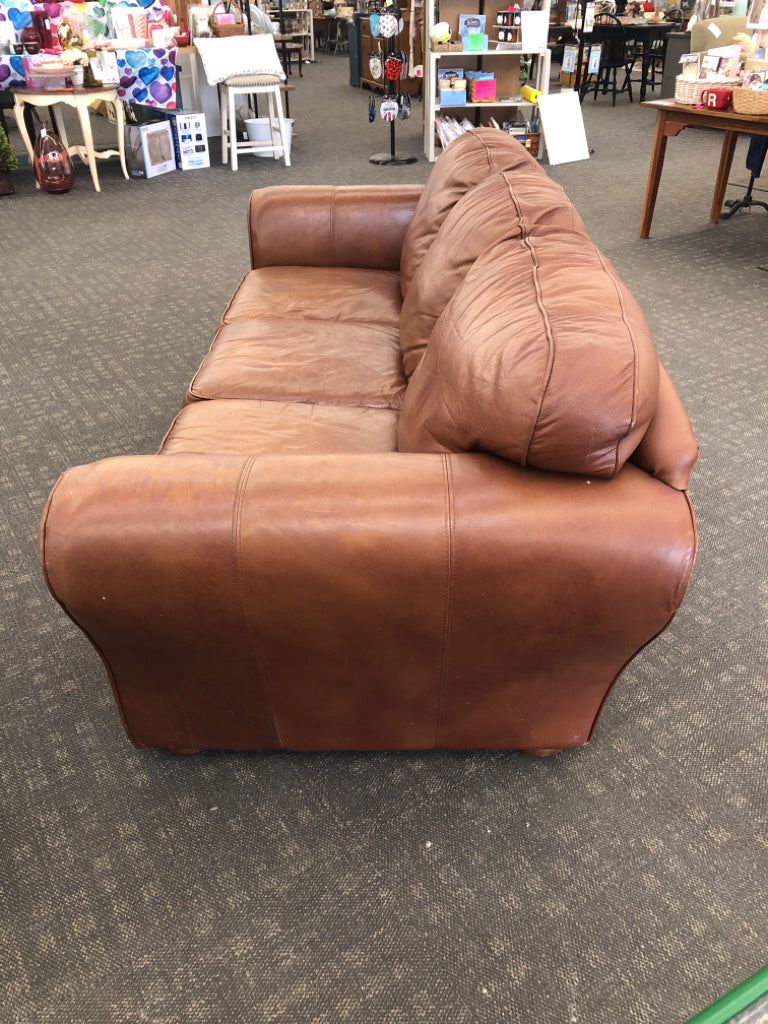 BROWN FAUX LEATHER COUCH.