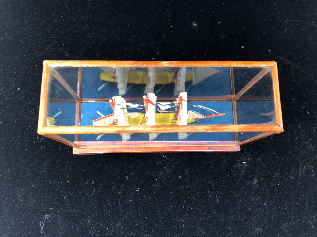 SMALL SHIP IN GLASS CASE.