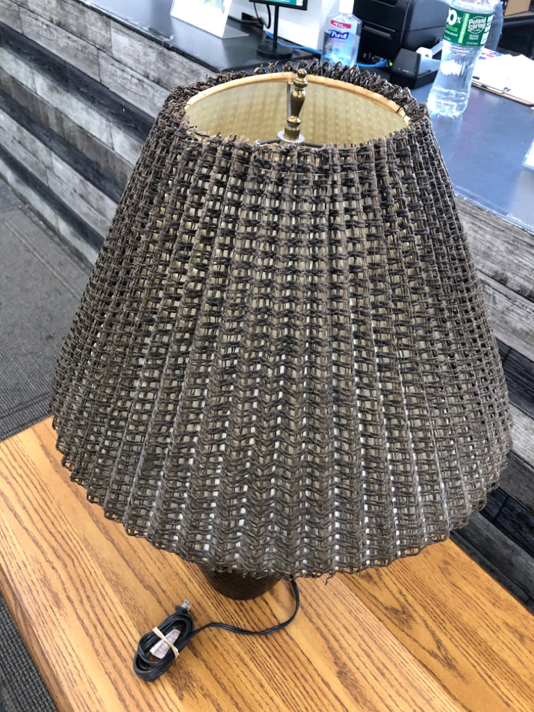 BRONZE BASE LAMP W/BROWN WICKER SHADE.