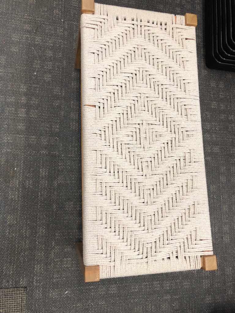 WOOD BENCH WITH GRAY ROPE SEATING.