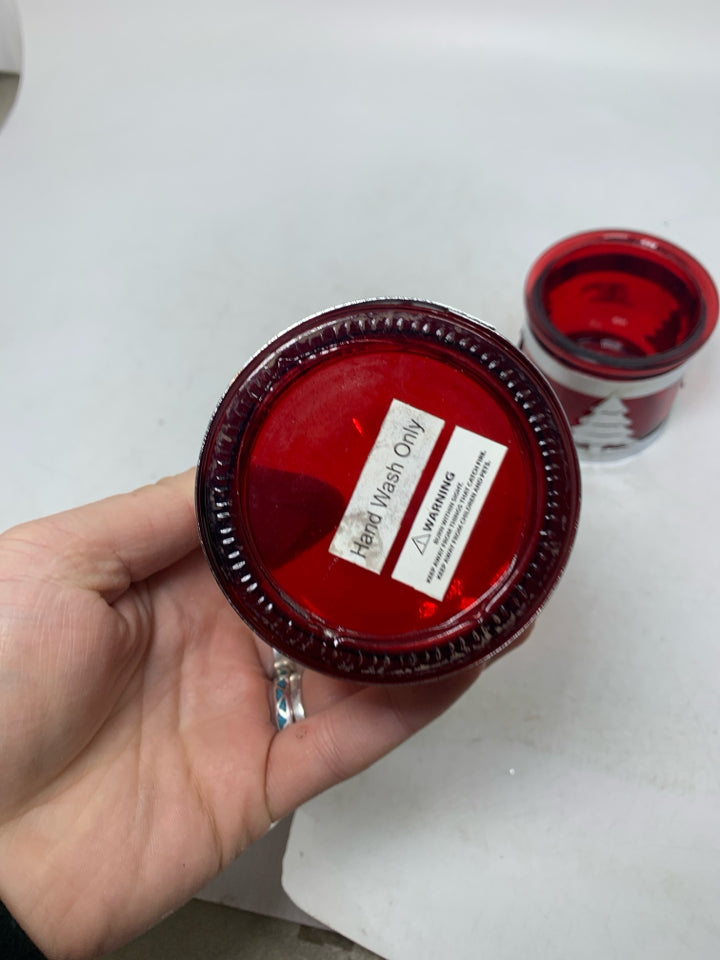 2 RED GLASS TEALIGHT HOLDERS W/ METAL TREE DEER CUT OUTS.