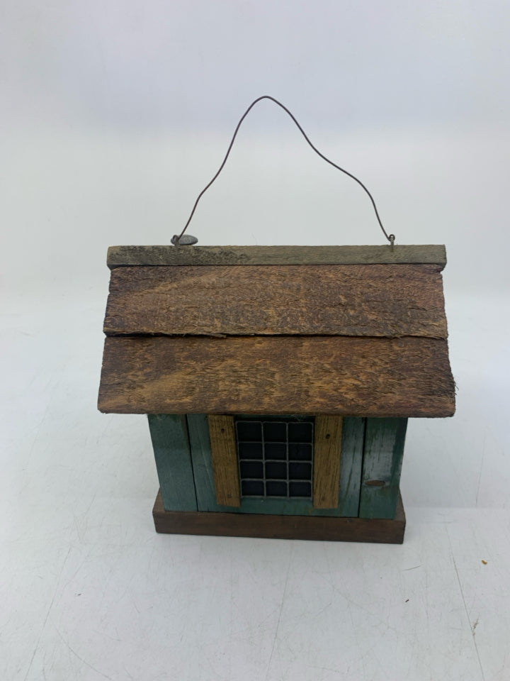 DISTRESSED GREEN CABIN W/ WINDOWS.