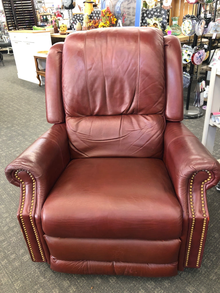 RED LEATHER RECLINER W/GOLD BUTTON DETAILS.