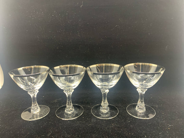 4 SMALL GLASSES W/ SILVER RIM.