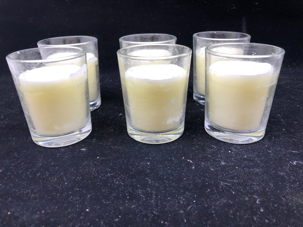 6 SCENTED VOTIVE CANDLES.