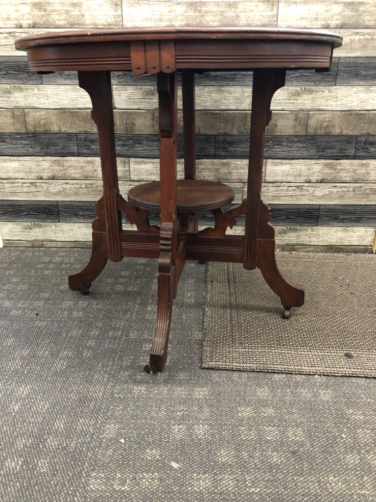 VTG DARK WOOD ROUND END TABLE ON WHEELS.