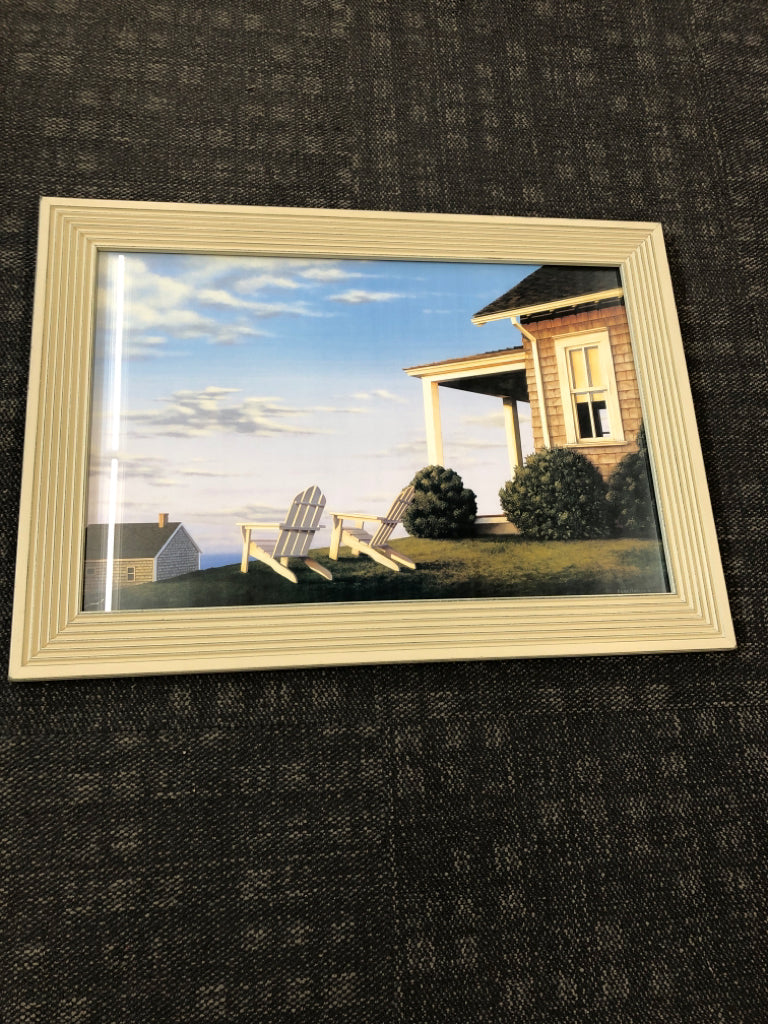 ADIRONDACK CHAIRS SUNSET PRINT IN WHITE WOOD FRAME.