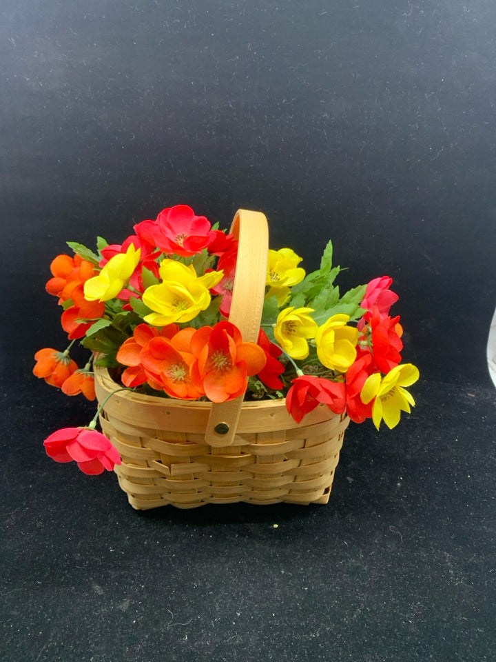 FAUX YELLOW AND PINK FLOWERS IN BASKET.