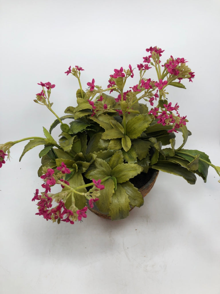FAUX PINK FLOWERS IN RUSTIC CEMENT POT.