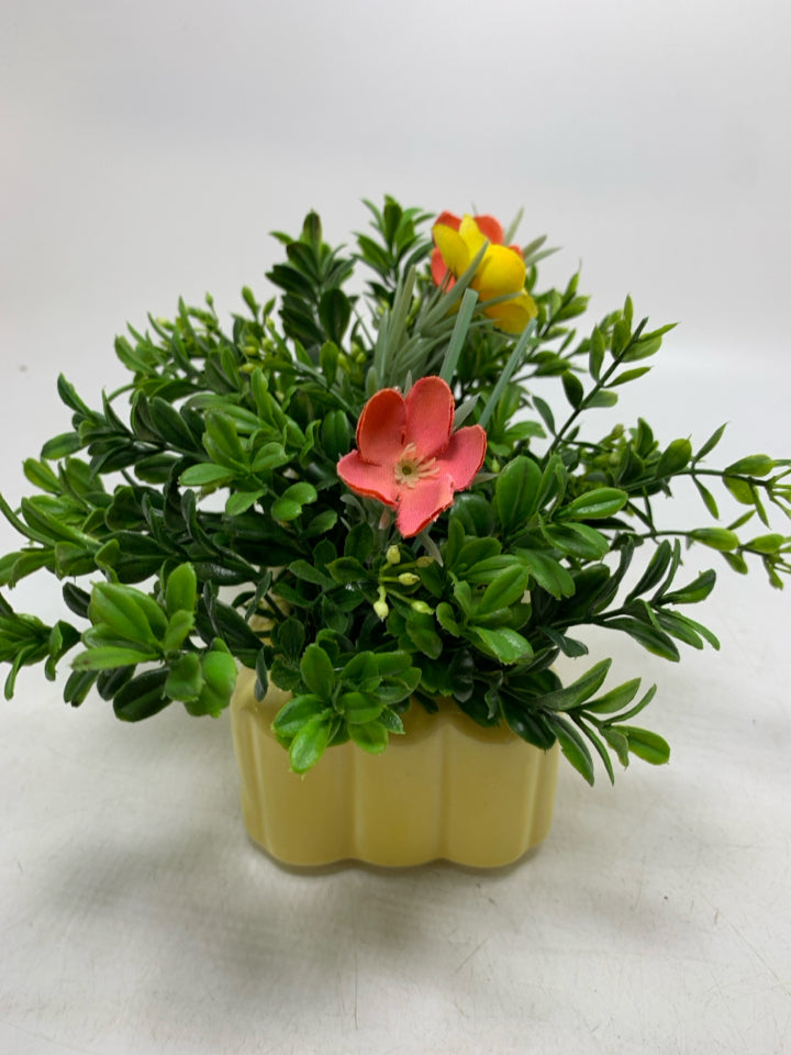 YELLOW PLANTER W/ FAUX FLOWERS.
