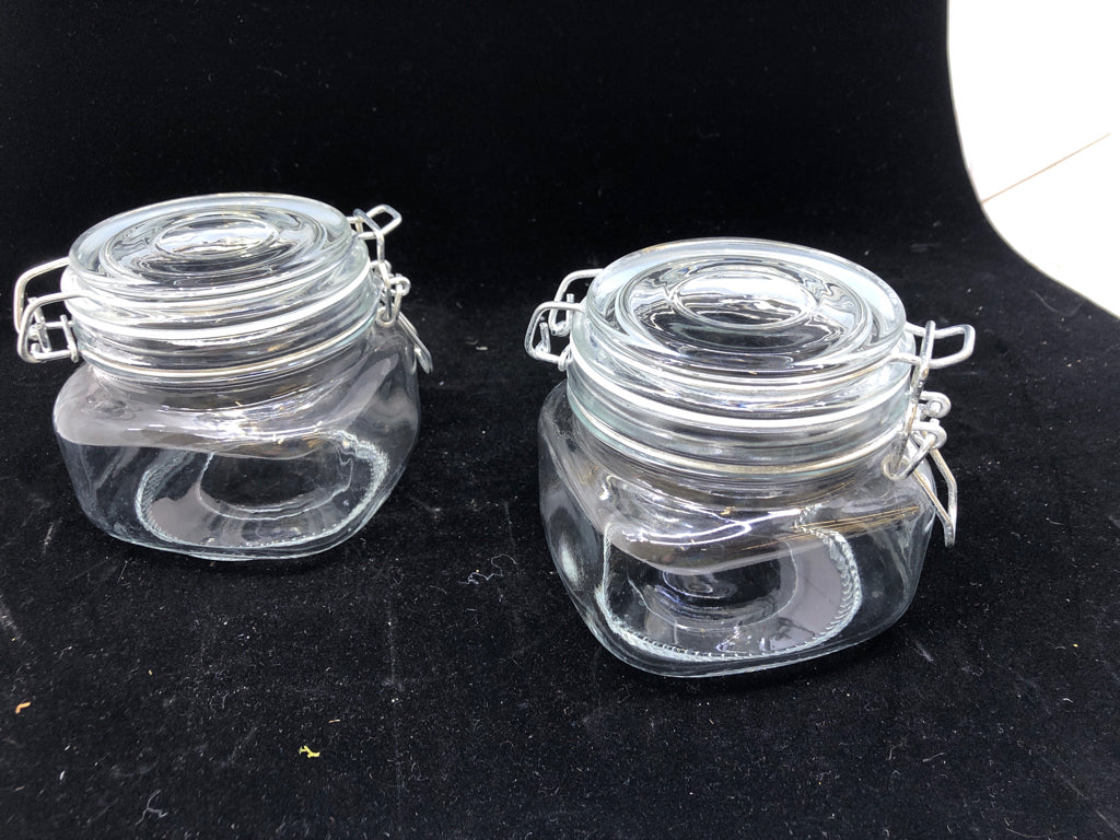 2 SHORT CLEAR GLASS CANISTERS W/ METAL CLASP LID.