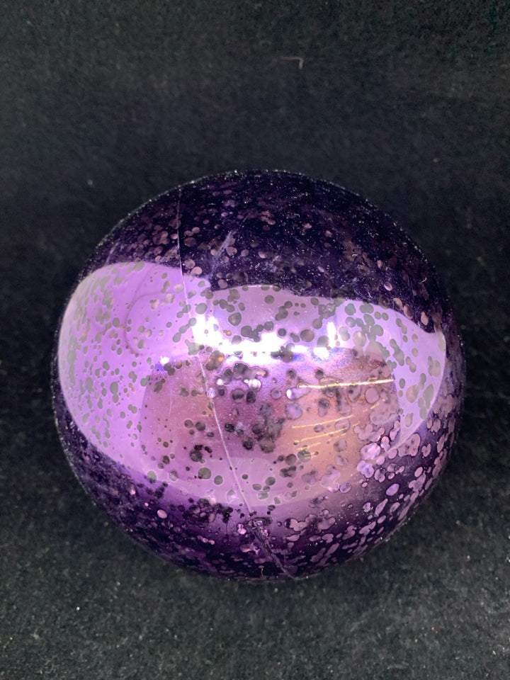 LARGE PLASTIC PURPLE ORNAMENT.