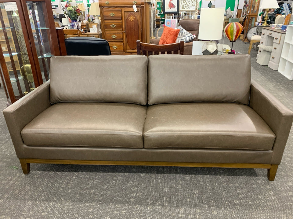 BROWN FAUX LEATHER COUCH.