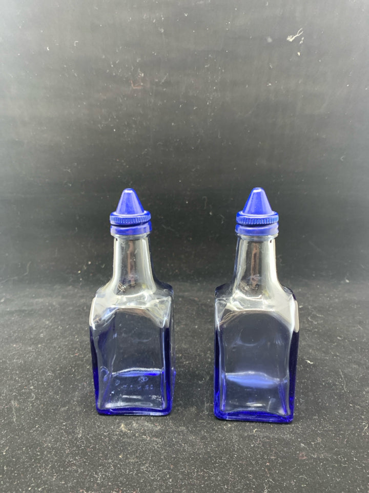 BLUE SQUARE GLASS OIL AND VINEGAR BOTTLES .