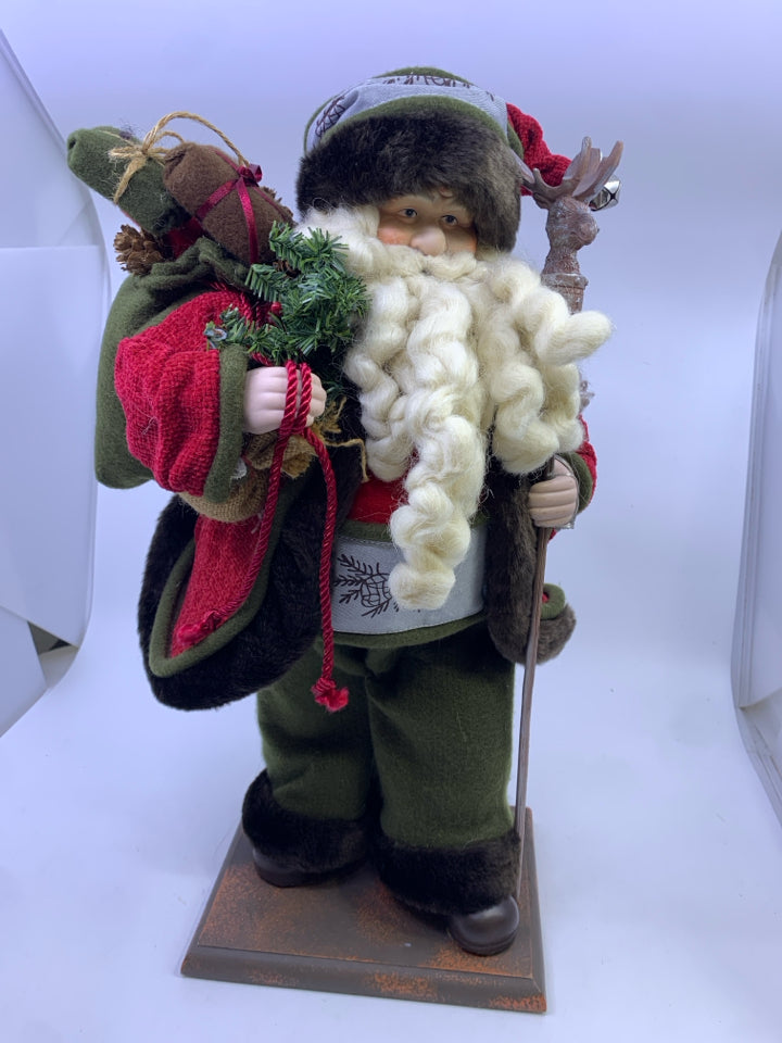 GREEN SANTA WITH DEER POLE HOLDING SACK.
