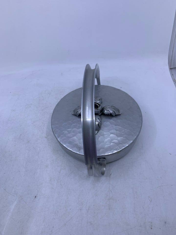 SILVER METAL HAMMERED SHALLOW W/ HANDLE EMBOSSED FLORAL ON LID.