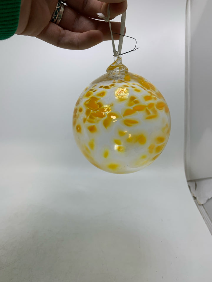 BLOWN GLASS CLEAR W/ YELLOW SPECKS ORNAMENT.