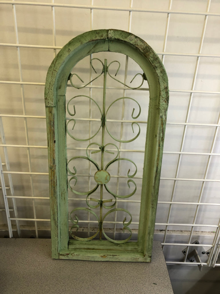 DISTRESSED GREEN PAINTED ARCH W/ METAL SCROLL WALL ART.