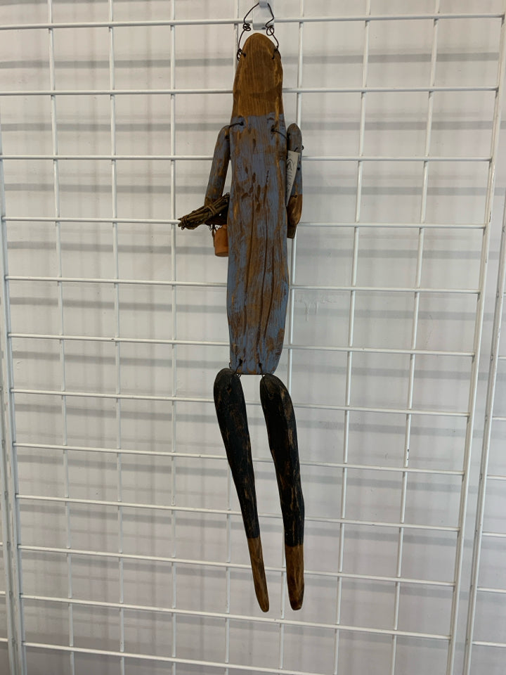PRIMITIVE WOOD DOLL W WATERING CAN WALL HANGING.