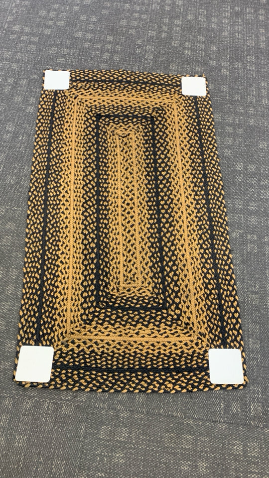 BLACK/BEIGE BRAIDED WOVEN  RUG.