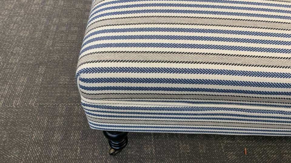 LONG BLUE STRIPPED OTTOMAN/BENCH ON WHEELS.