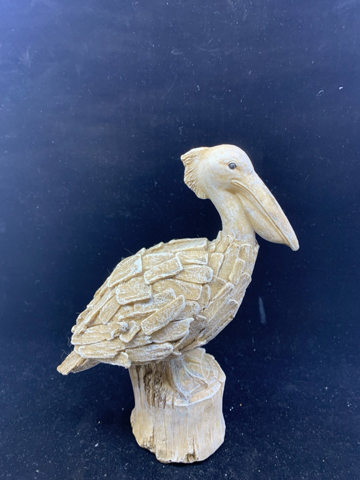 PELICAN ON A PIECE OF WOOD.