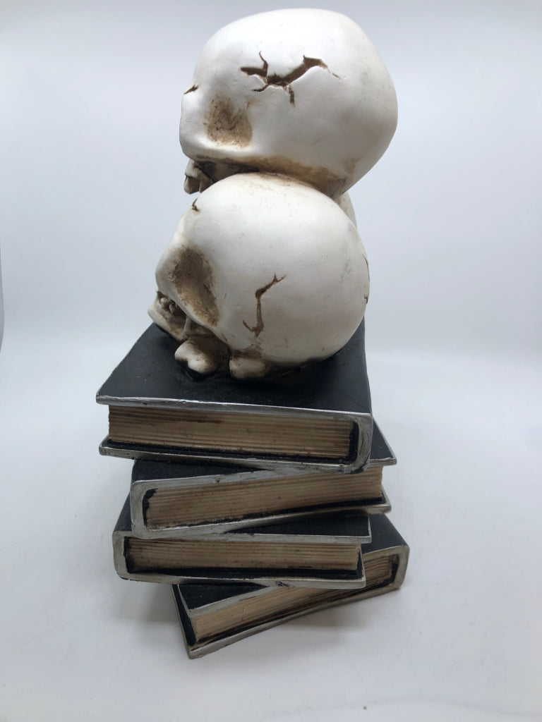 SKULLS ON BOOK STACK RESIN FIGURE.