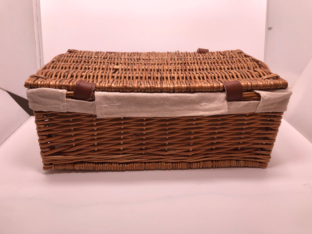 WOVEN BASKET W/FABRIC LINER AND FAUX LEATHER BUCKLES.