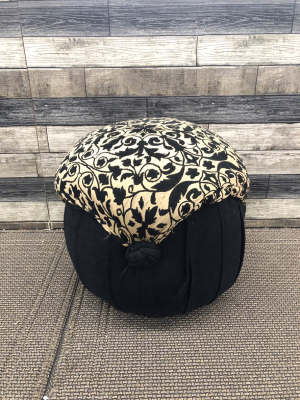 BLACK AND BROWN UPHOLSTERED STOOL/ POUF.