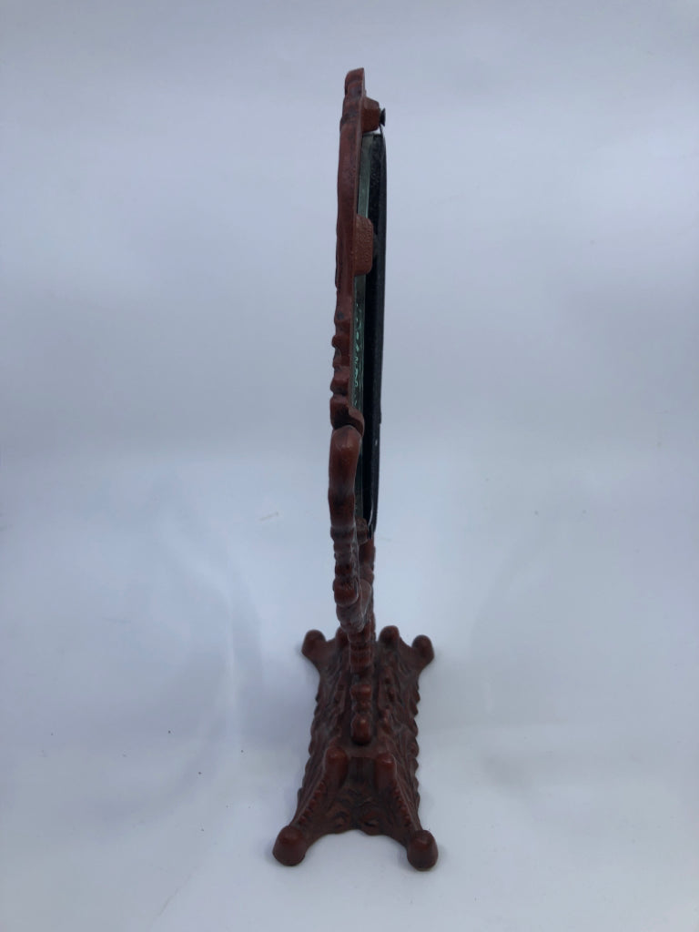 HEAVY RED METAL ORNATE MIRROR.