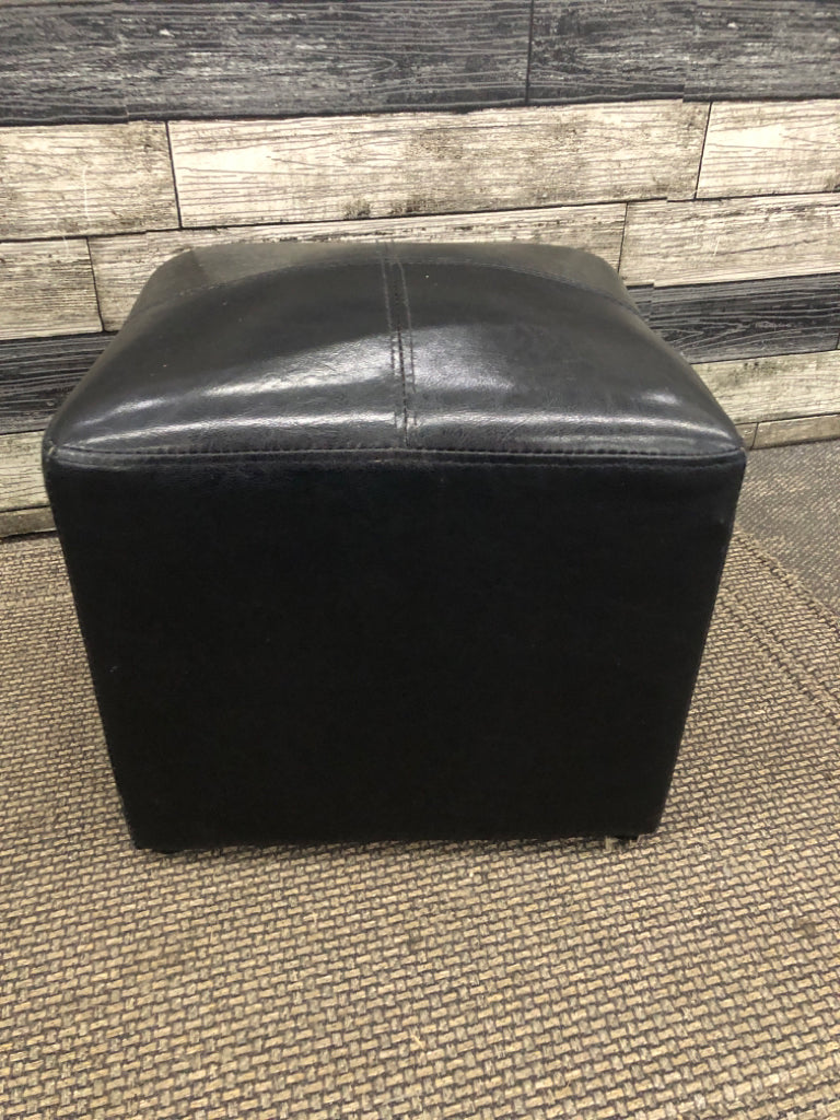 SM BLACK FAUX LEATHER CUBE OTTOMAN.