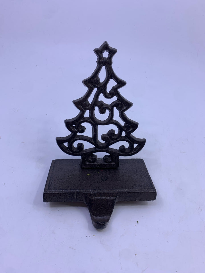 BROWN METAL CUTOUT TREE STOCKING HOLDER.