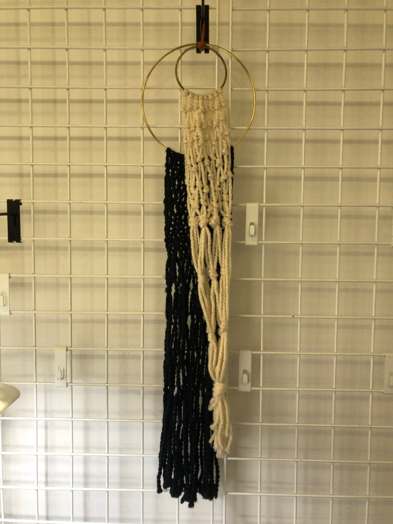 BLACK/WHITE MACRAME WALL HANGING W/ 2 GOLD RINGS.