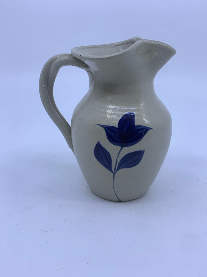 SMALL POTTERY JUG W/BLUE FLOWER.