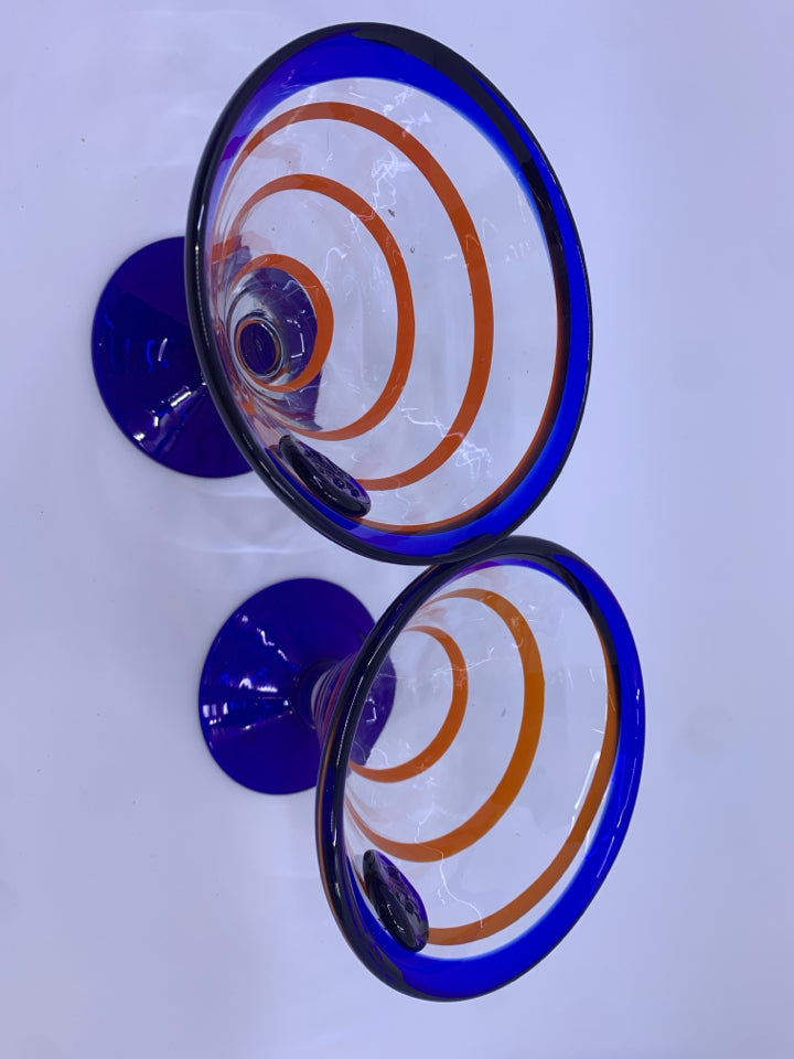 2 BLOWN GLASS FOOTED MARTINI GLASSES W/ COBALT BLUE W/ORANGE SWIRL.