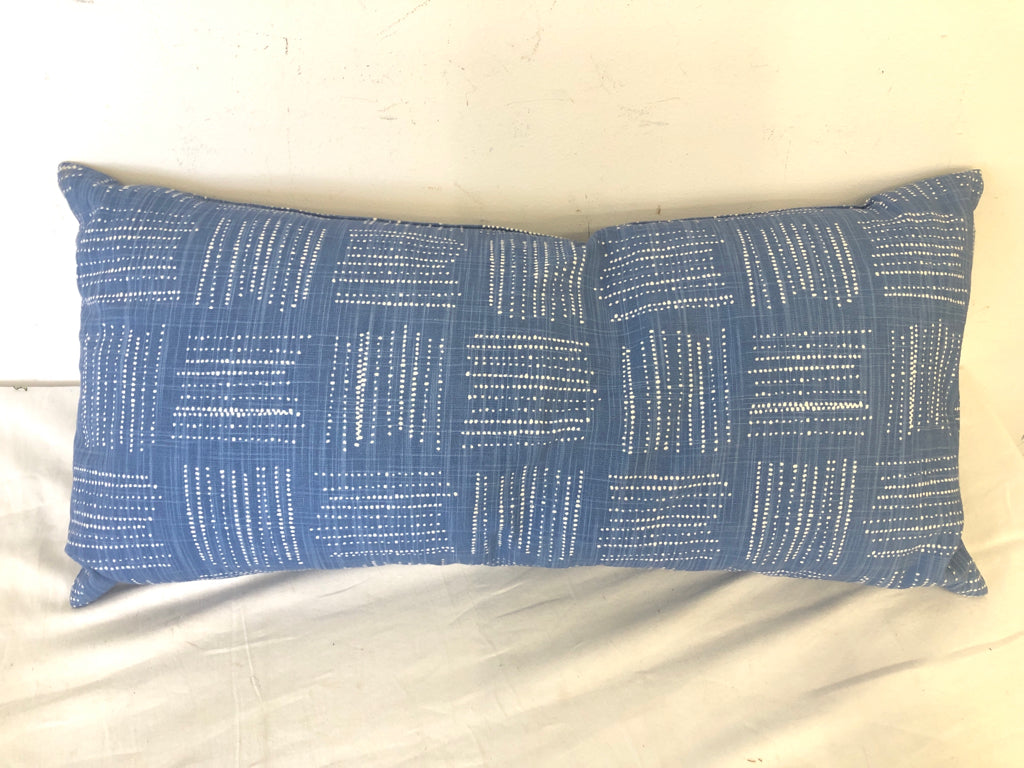 BLUE RECTANGLE PILLOW W/ WHITE SPOTTED SQUARES DESIGN.