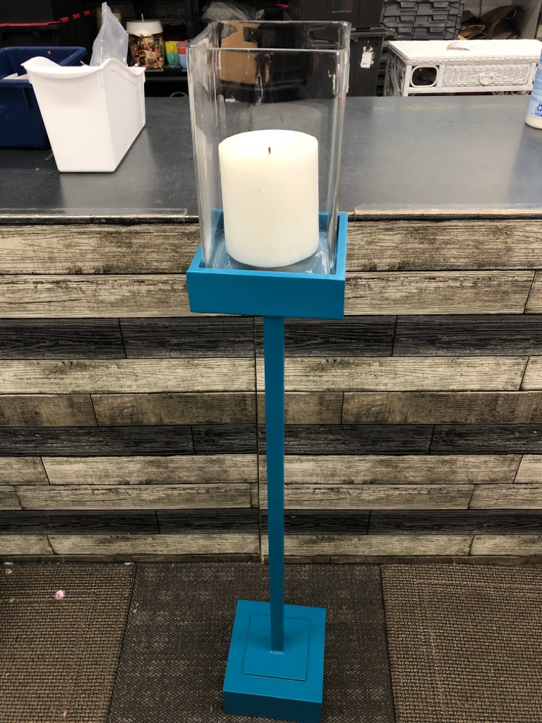 TALL BLUE SQUARE BASE CANDLE HOLDER W/CLEAR GLASS TOP.