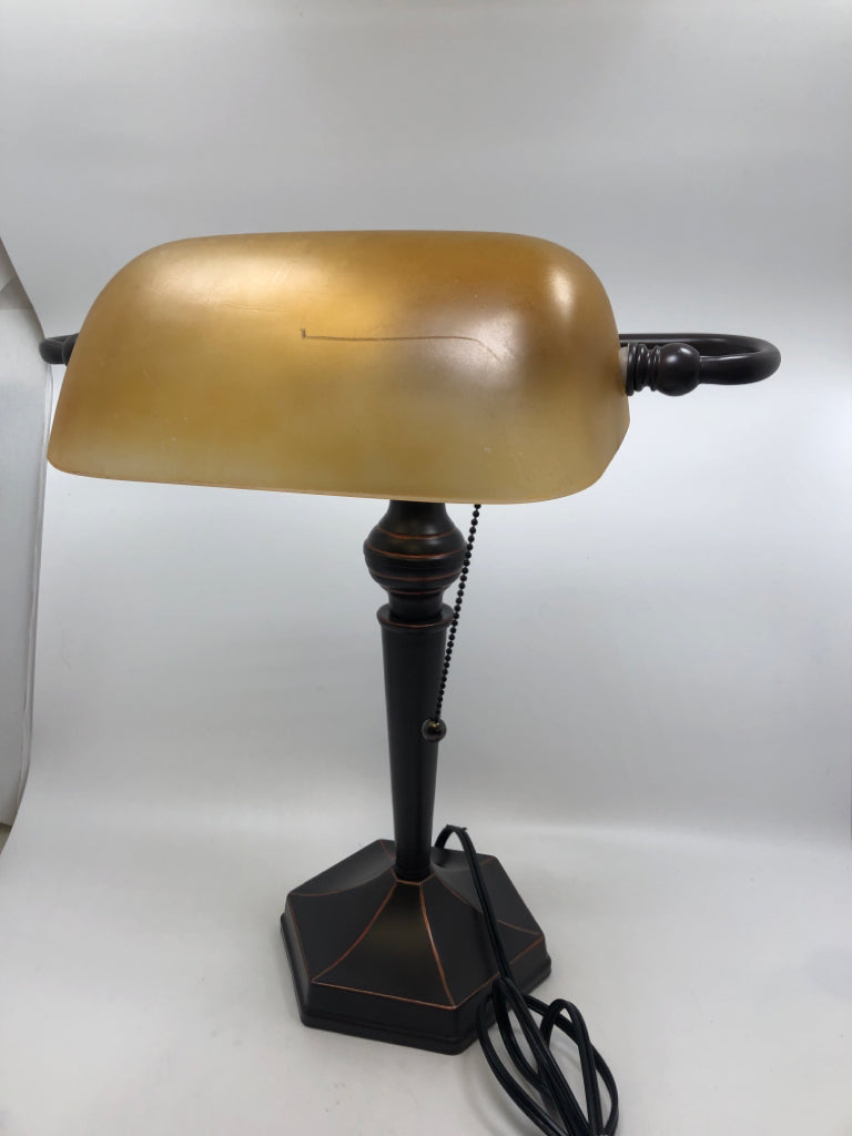 BRONZE BANKERS LAMP W/AMBER GLASS SHADE.