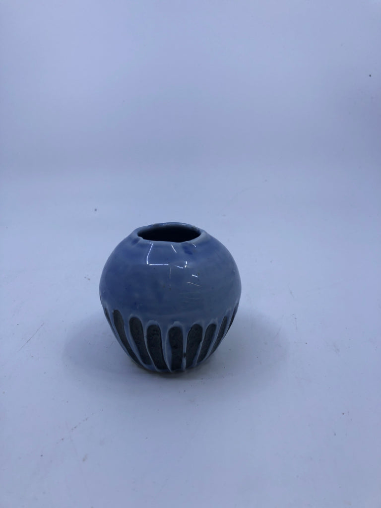 SHORT LIGHT BLUE VASE W/ BLACK LINES ON BOTTOM.