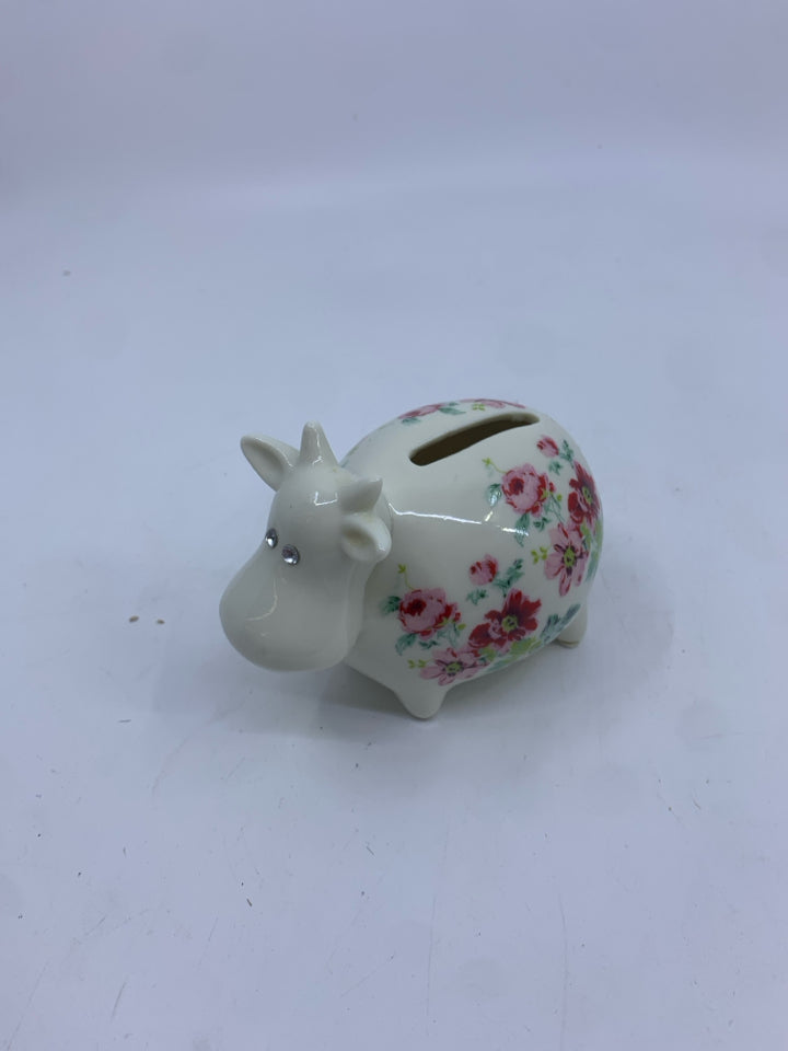 COW PIGGY BANK WITH RED FLOWERS.