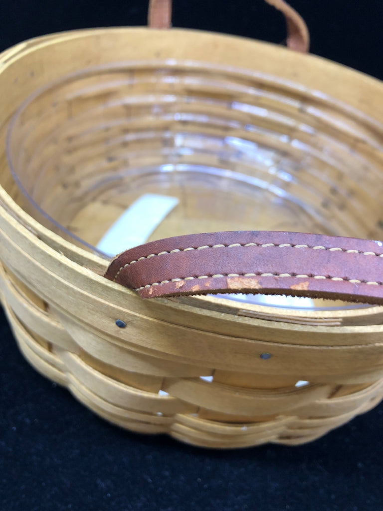 ROUND BASKET W PLASTIC LINER AND LEATHER HANDLES.