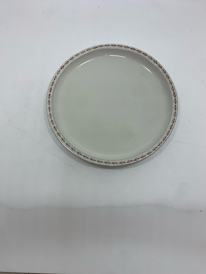 4 WHITE STONEWARE PLATES W/RED DOTTED RIM.