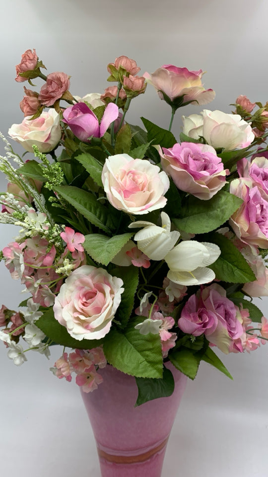 FAUX PINK ROSES IN PINK GLASS VASE.