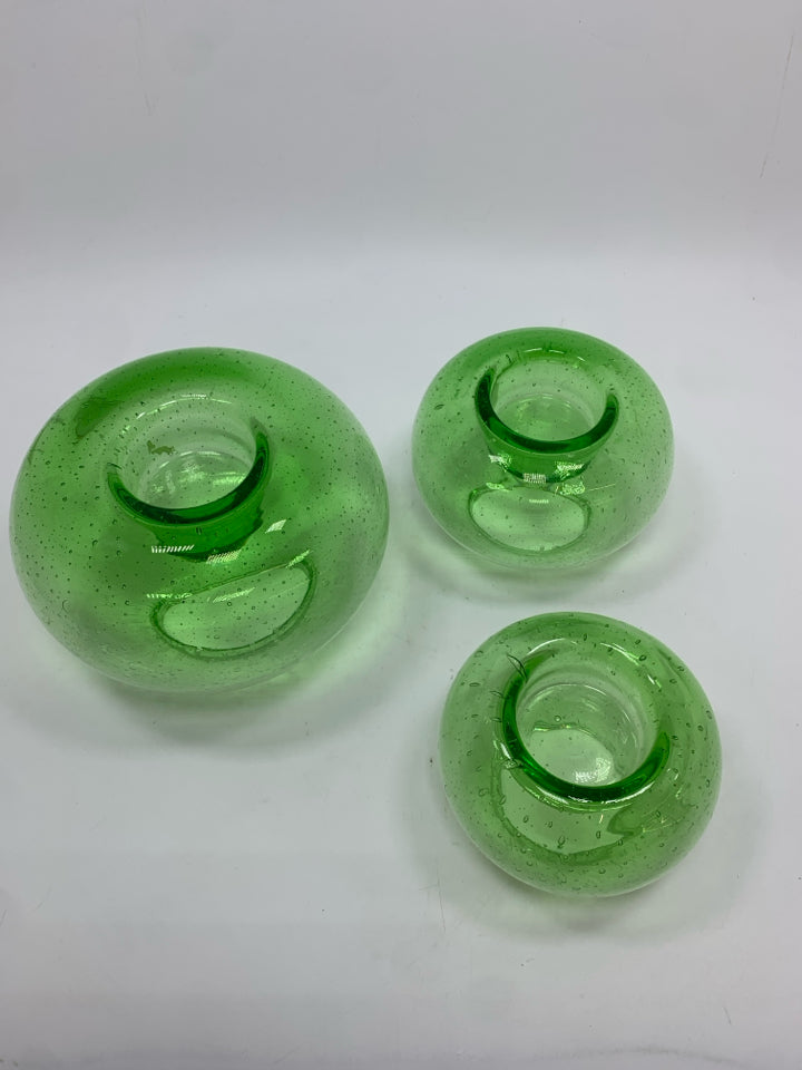 3 GREEN GLASS VOTIVE CANDLE HOLDERS.