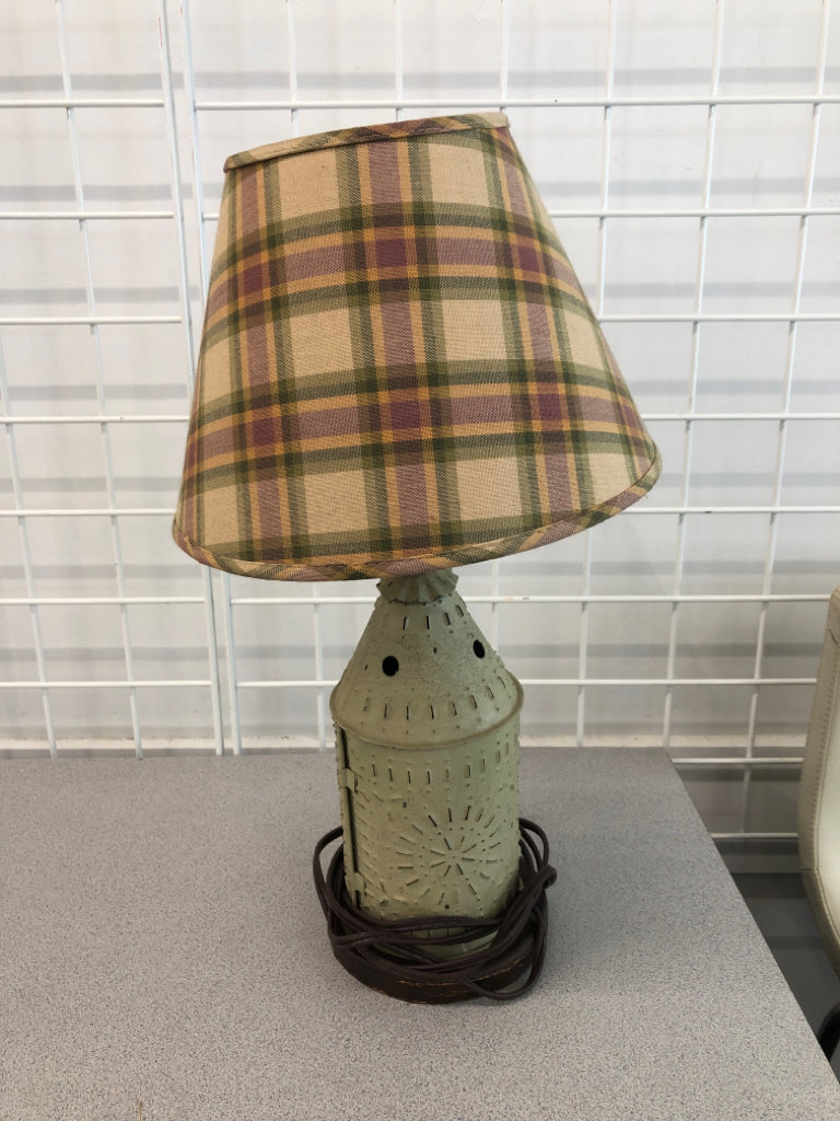 PUNCHED METAL PRIMITIVE LAMP W/PLAID SHADE.