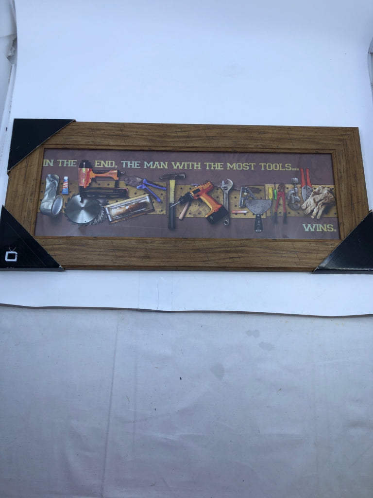 NIP THE MAN WITH THE MOST TOOLS WINS WALL ART.