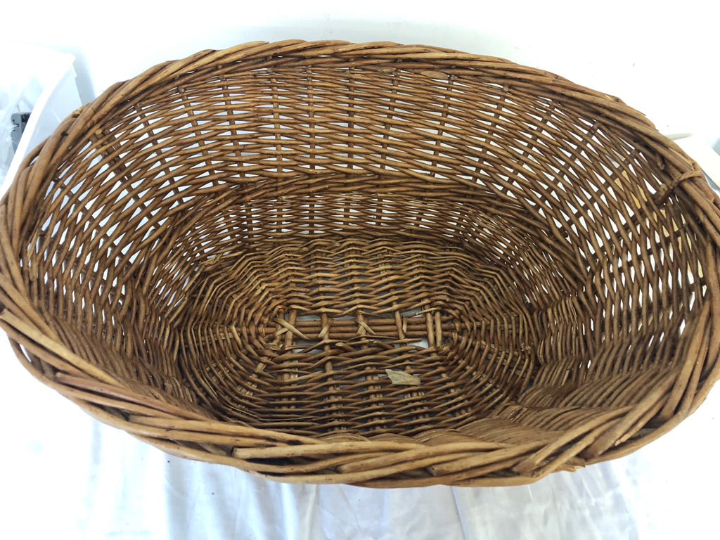 CARMEL COLORED WICKER LAUNDRY BASKET.