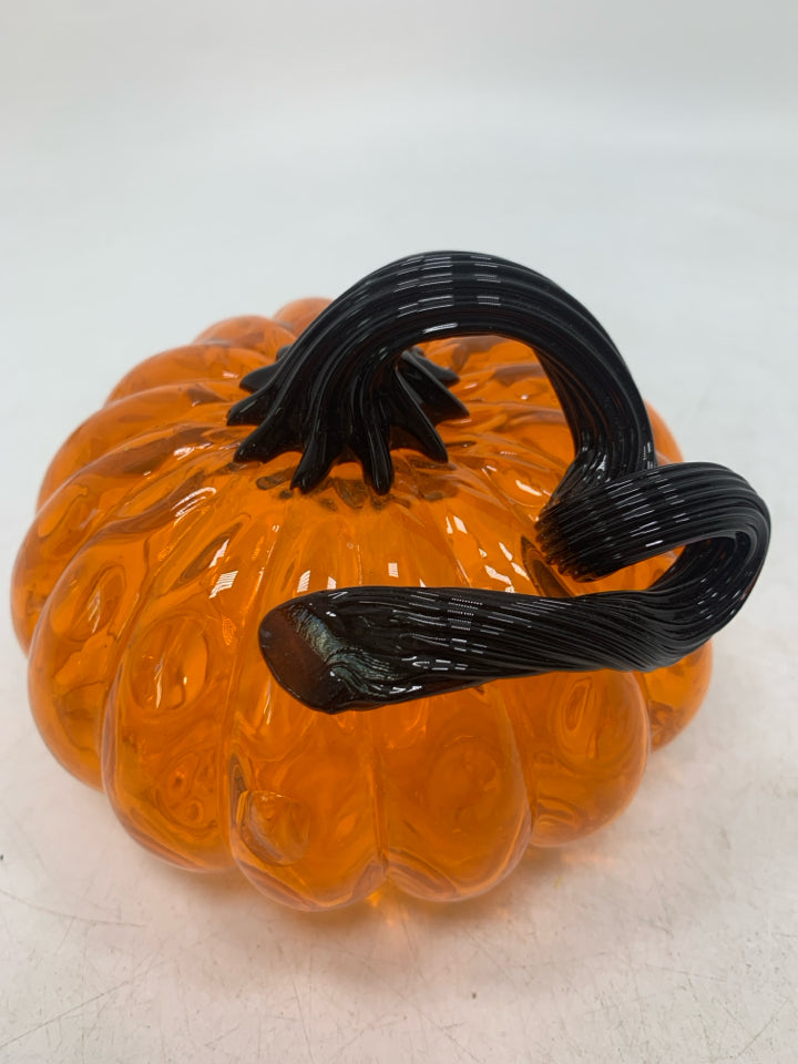 ORANGE GLASS PUMPKIN WITH BLACK STEM.